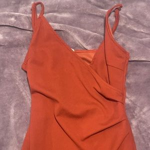 A medium sized burnt orange dress with slit. Never worn and runs smaller.